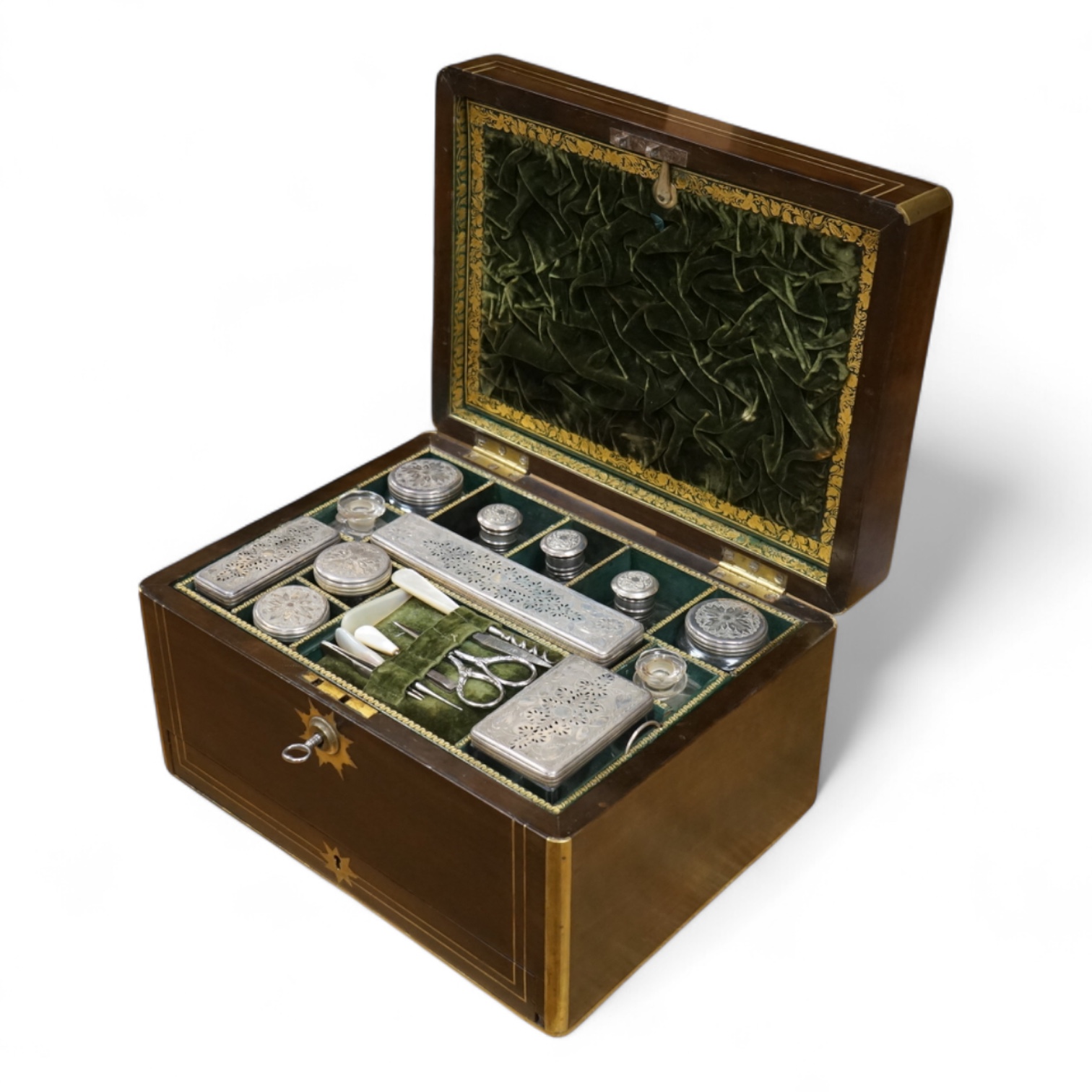 A mid 19th century mahogany brass bound and mounted toilet box, with tooled leather and velvet interior. Fitted inside with glass plated topped bottles and boxes. 31cm wide x 19cm high